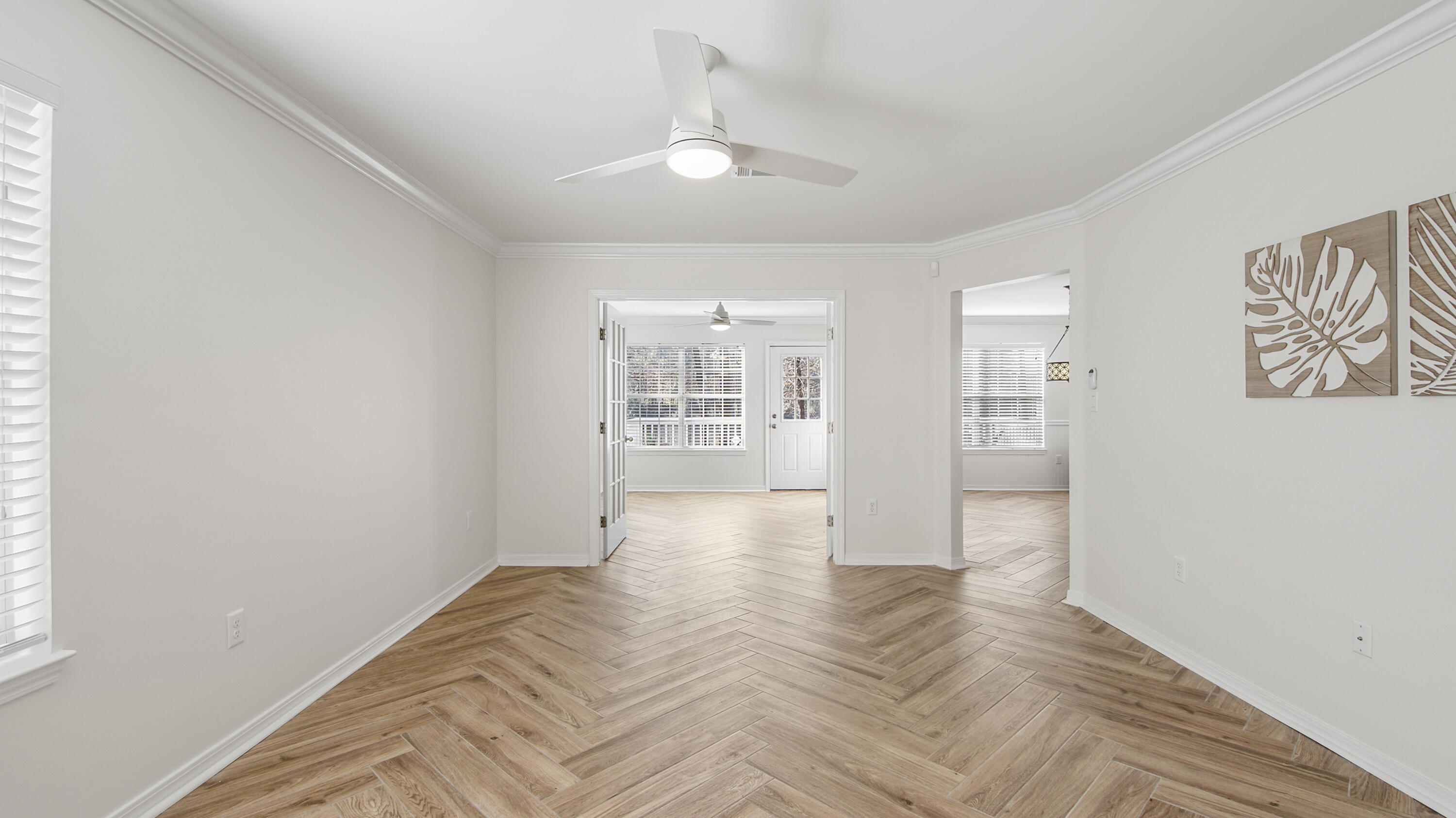 302 Liriope Loop Destin, FL 32541 - Photo 10 of 59 a view of an empty room with wooden floor and a window