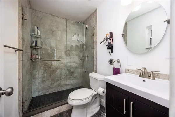 a bathroom with a sink toilet and shower