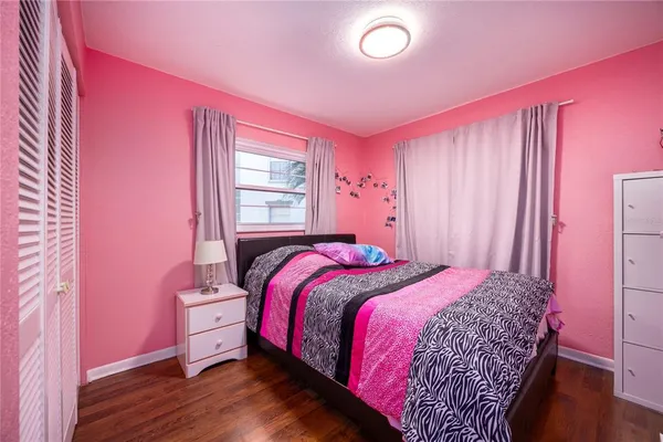 a bed room with a bed and a chair