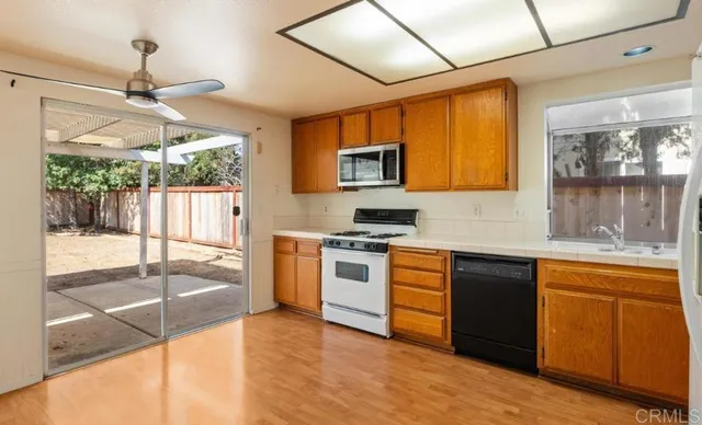 a kitchen with stainless steel appliances granite countertop a stove and a sink