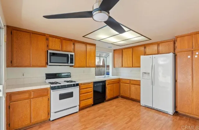 a kitchen with stainless steel appliances granite countertop a stove sink and refrigerator