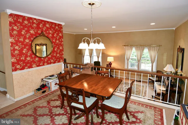 a view of a dining room with furniture and chandelier