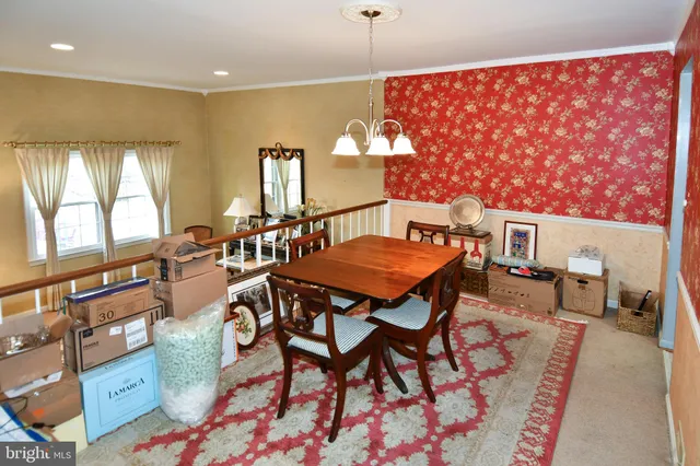 a view of a dining room with furniture and a window