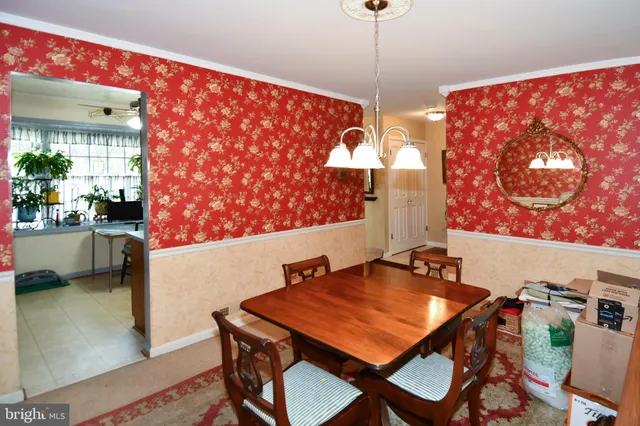 a view of a dining room with furniture and chandelier