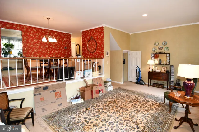 a living room with furniture a rug and a large window