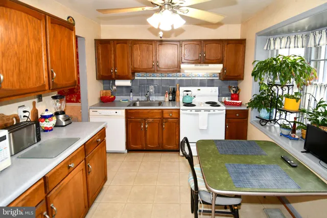 a kitchen with a table chairs stove and cabinets