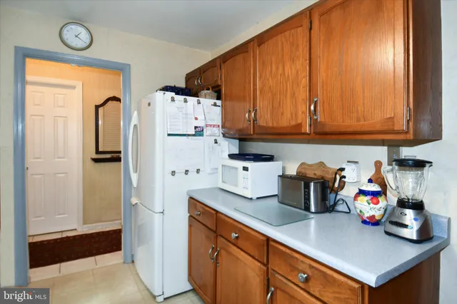 a kitchen with refrigerator and cabinets