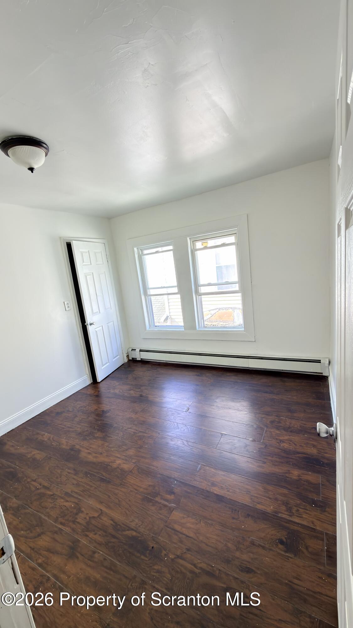 2115-2117 Wayne Avenue Scranton, PA 18508 - Photo 14 of 44 an empty room with wooden floor and windows
