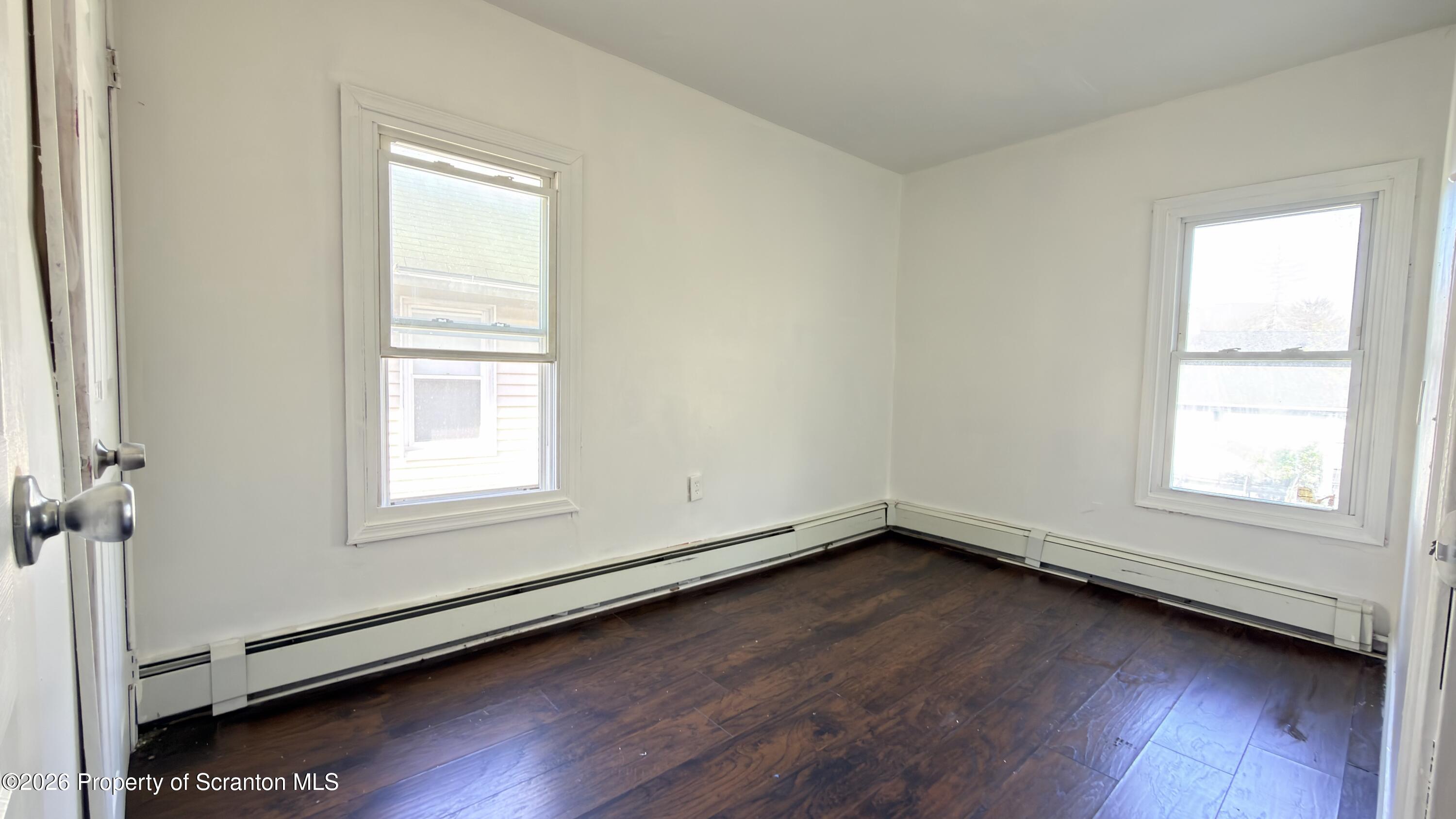 2115-2117 Wayne Avenue Scranton, PA 18508 - Photo 19 of 44 an empty room with wooden floor and windows
