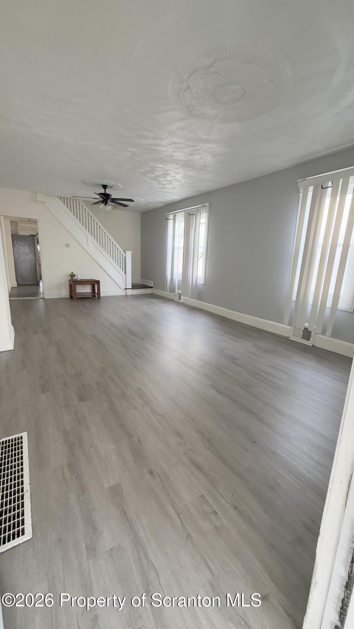 2115-2117 Wayne Avenue Scranton, PA 18508 - Photo 23 of 44 an empty room with wooden floor and windows