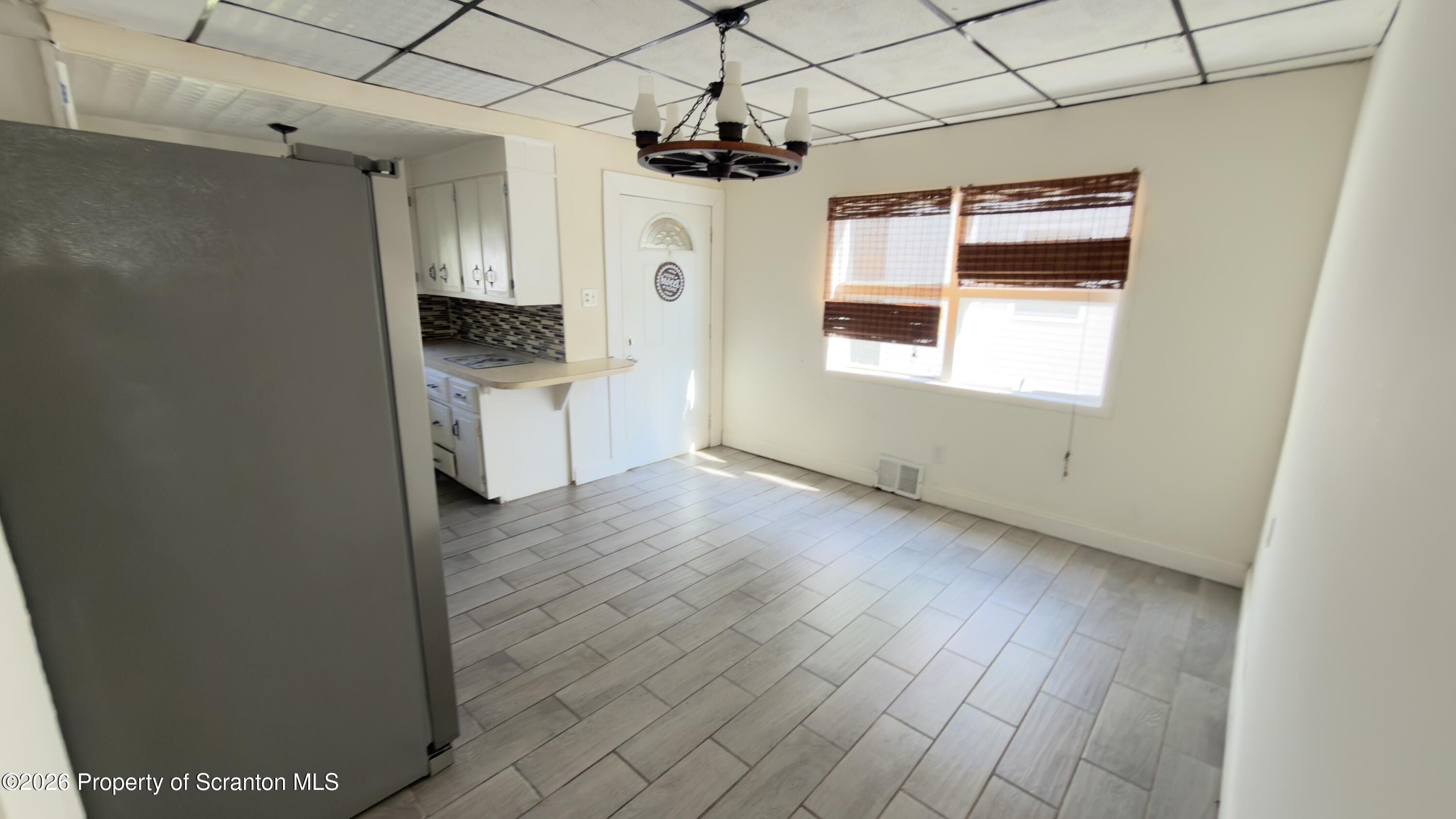 2115-2117 Wayne Avenue Scranton, PA 18508 - Photo 24 of 44 a kitchen with a sink a refrigerator and window
