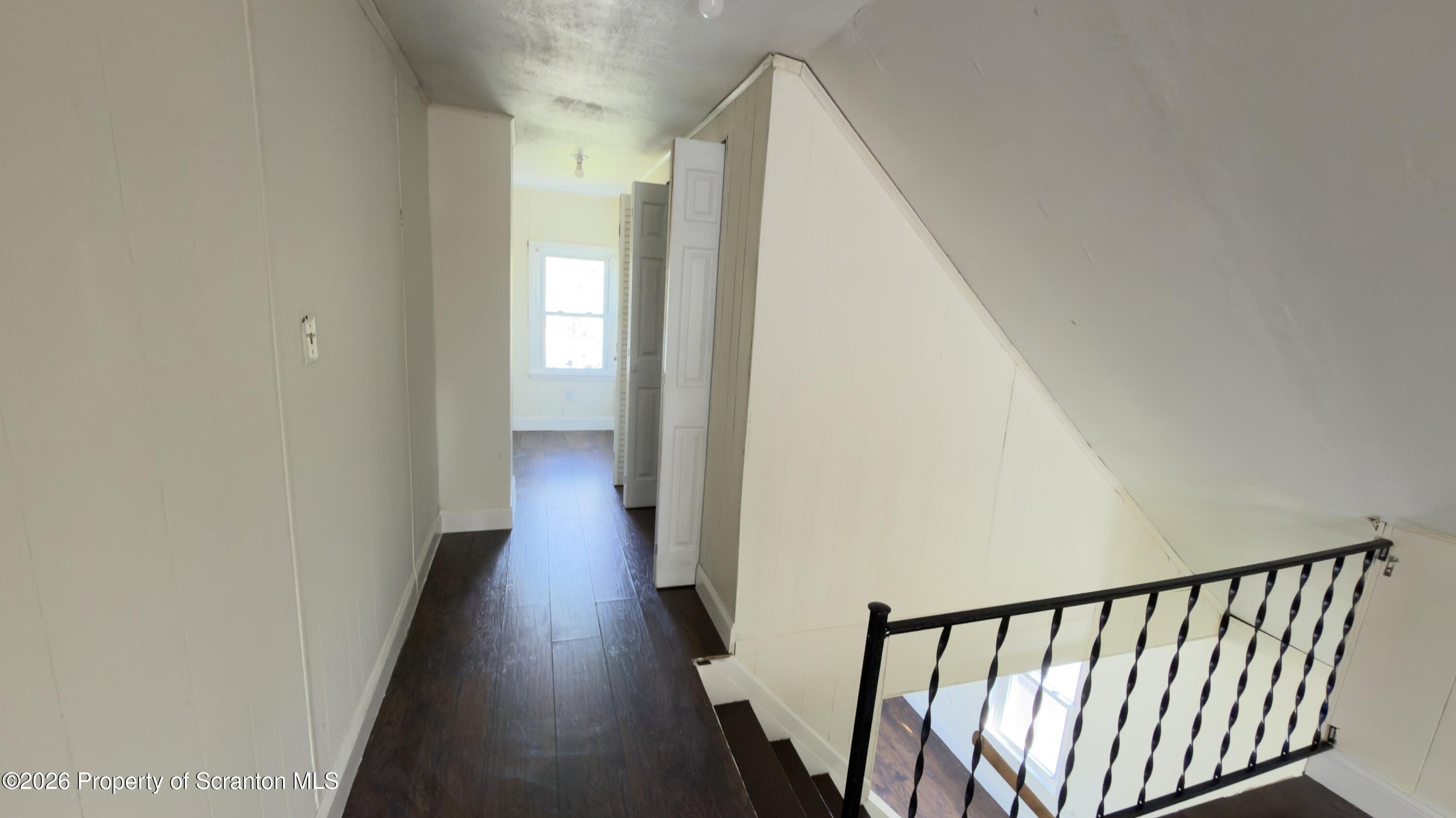 2115-2117 Wayne Avenue Scranton, PA 18508 - Photo 27 of 44 a view of a hallway with wooden floor