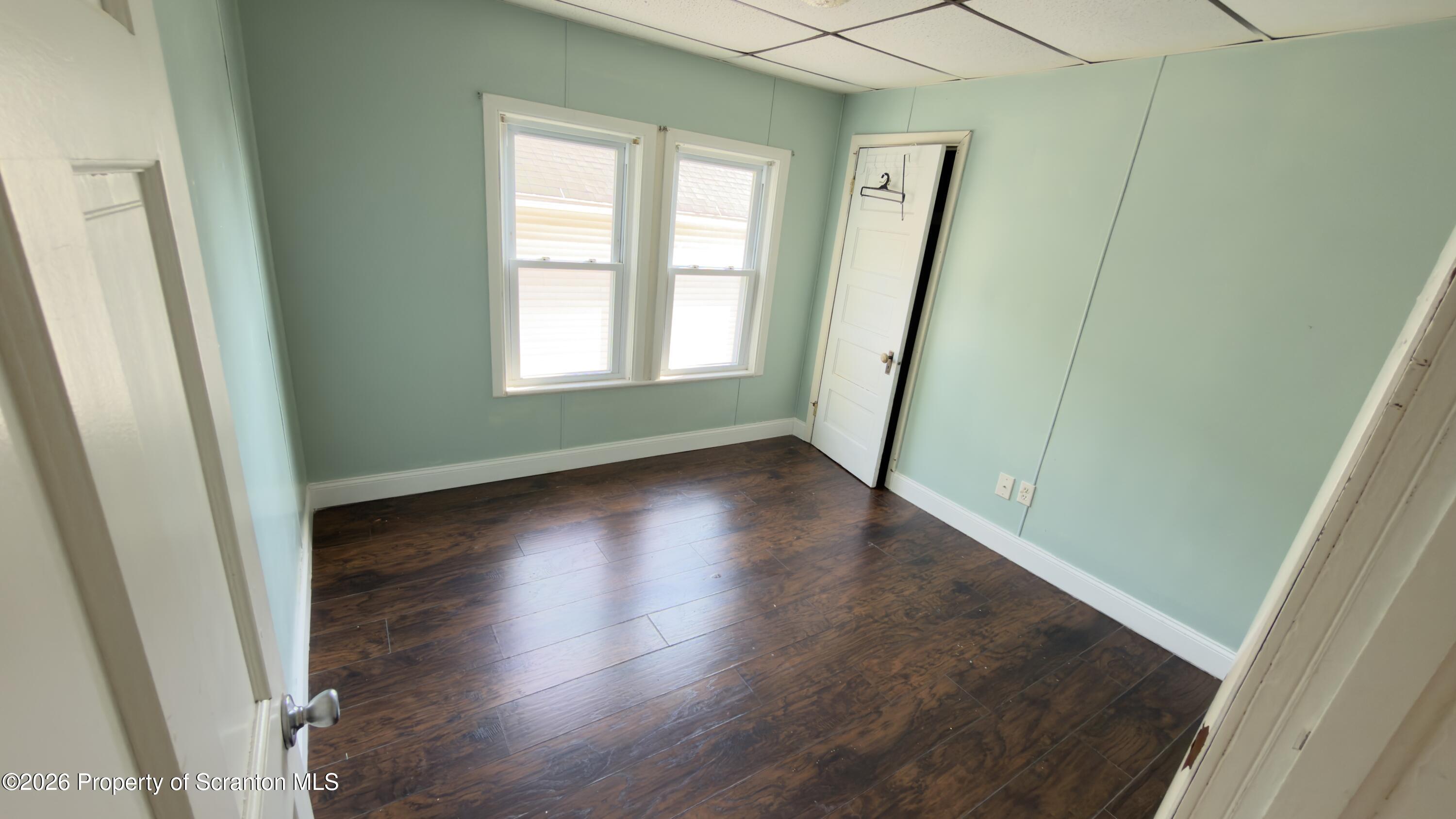 2115-2117 Wayne Avenue Scranton, PA 18508 - Photo 28 of 44 an empty room with wooden floor and windows