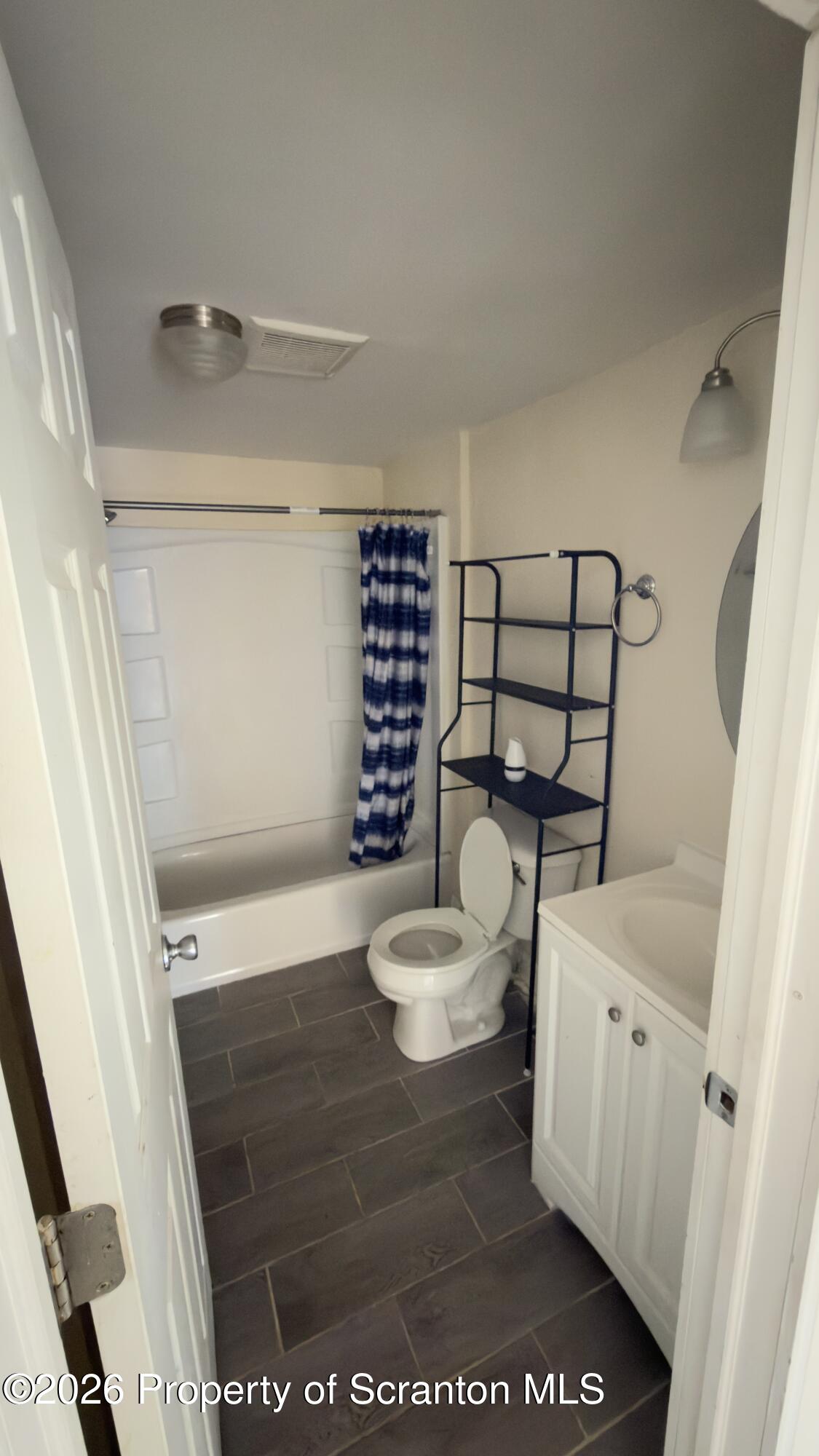 2115-2117 Wayne Avenue Scranton, PA 18508 - Photo 30 of 44 a bathroom with a toilet and a shower