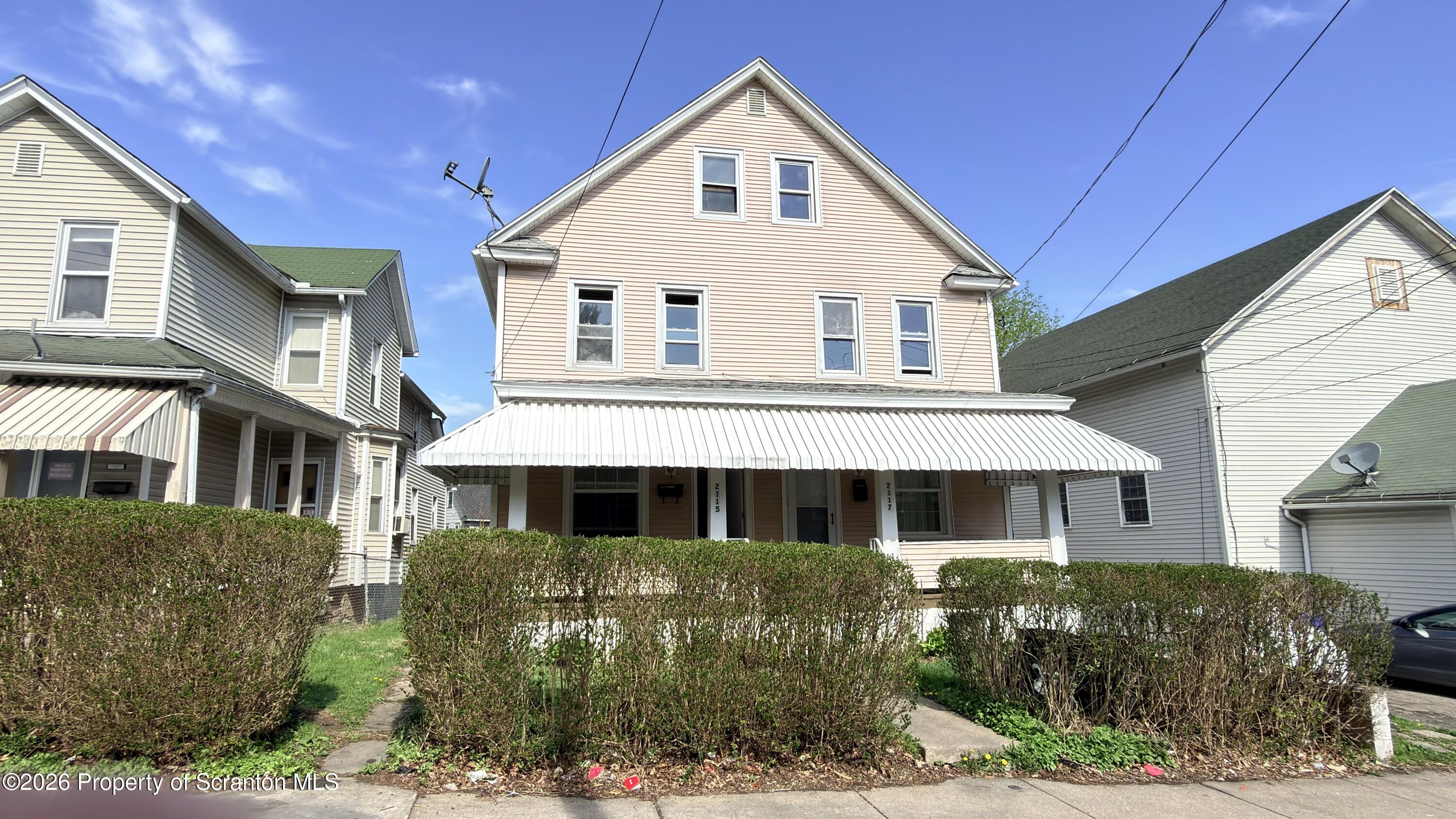 2115-2117 Wayne Avenue Scranton, PA 18508 - Photo 3 of 44 a front view of a house with a yard