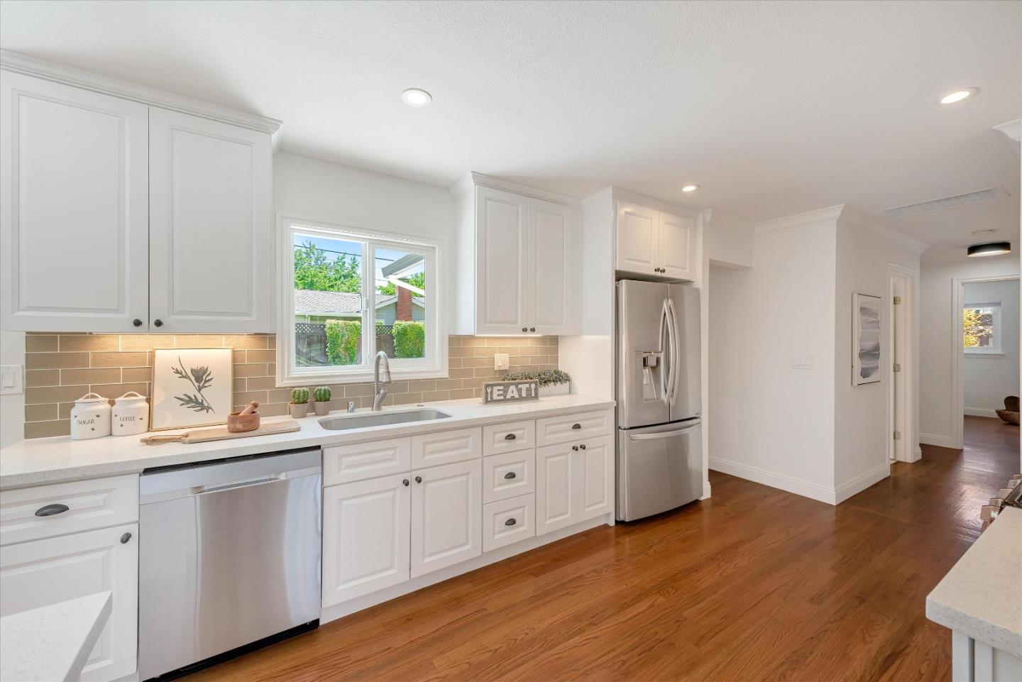 1314 Crestfield Drive San Jose, CA 95125 - Photo 11 of 43 a kitchen with stainless steel appliances white cabinets and wooden floors