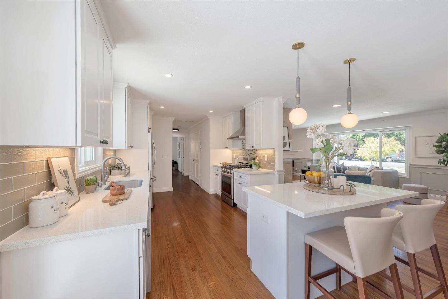 1314 Crestfield Drive San Jose, CA 95125 - Photo 9 of 43 a kitchen with kitchen island a dining table chairs sink and white cabinets