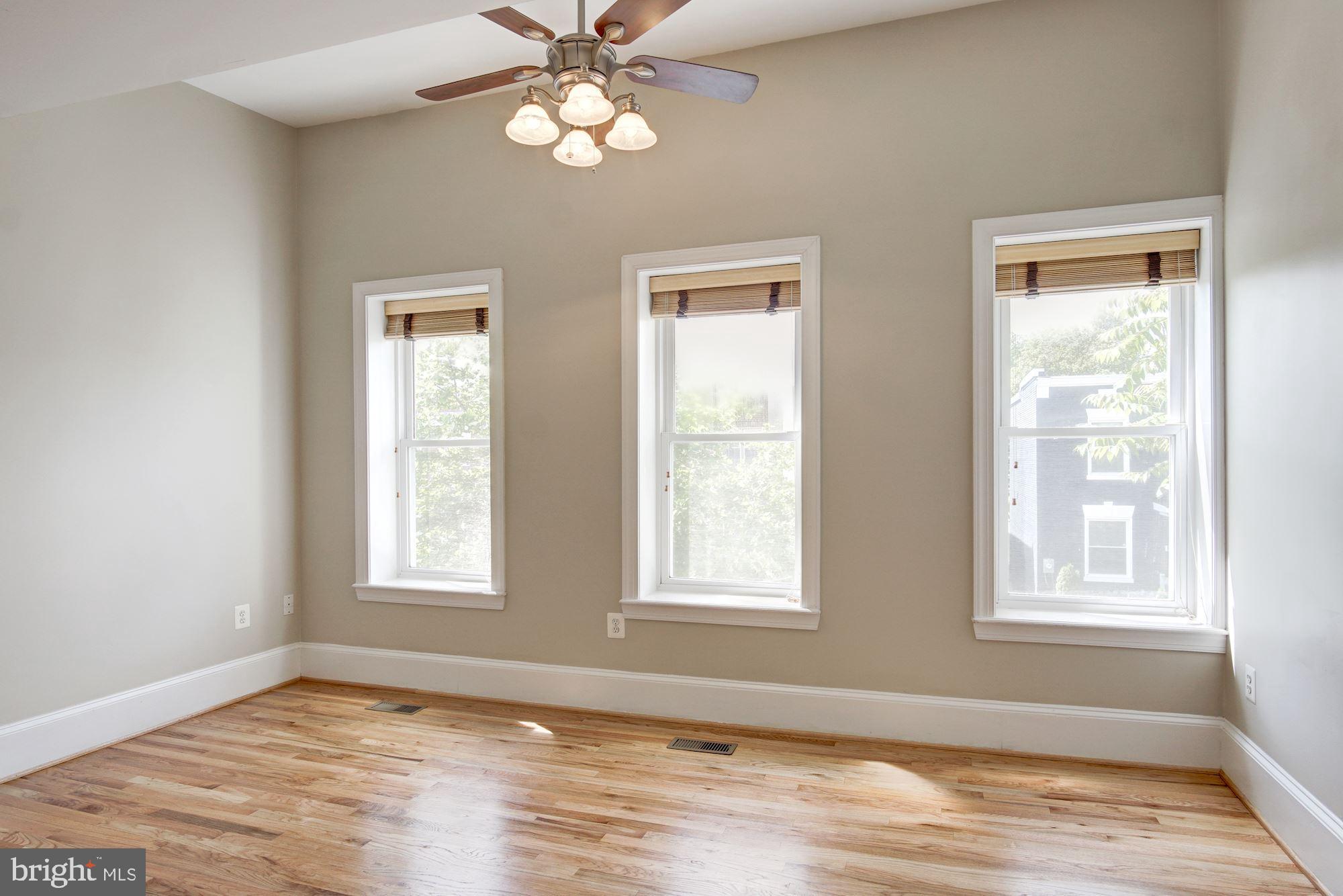 1414 D Street Northeast Washington, DC 20002 - Photo 11 of 25 a view of an empty room with a window and wooden floor
