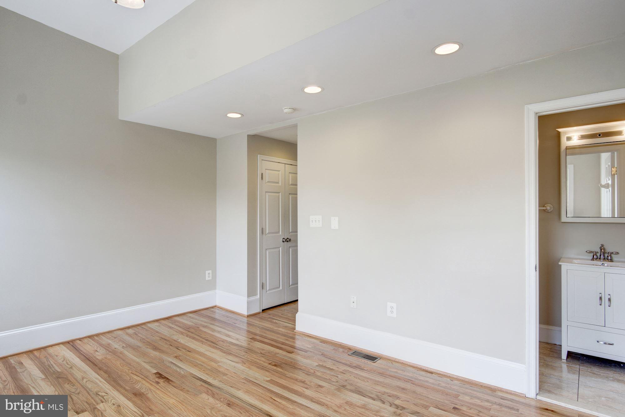 1414 D Street Northeast Washington, DC 20002 - Photo 12 of 25 a view of an empty room with wooden floor and closet