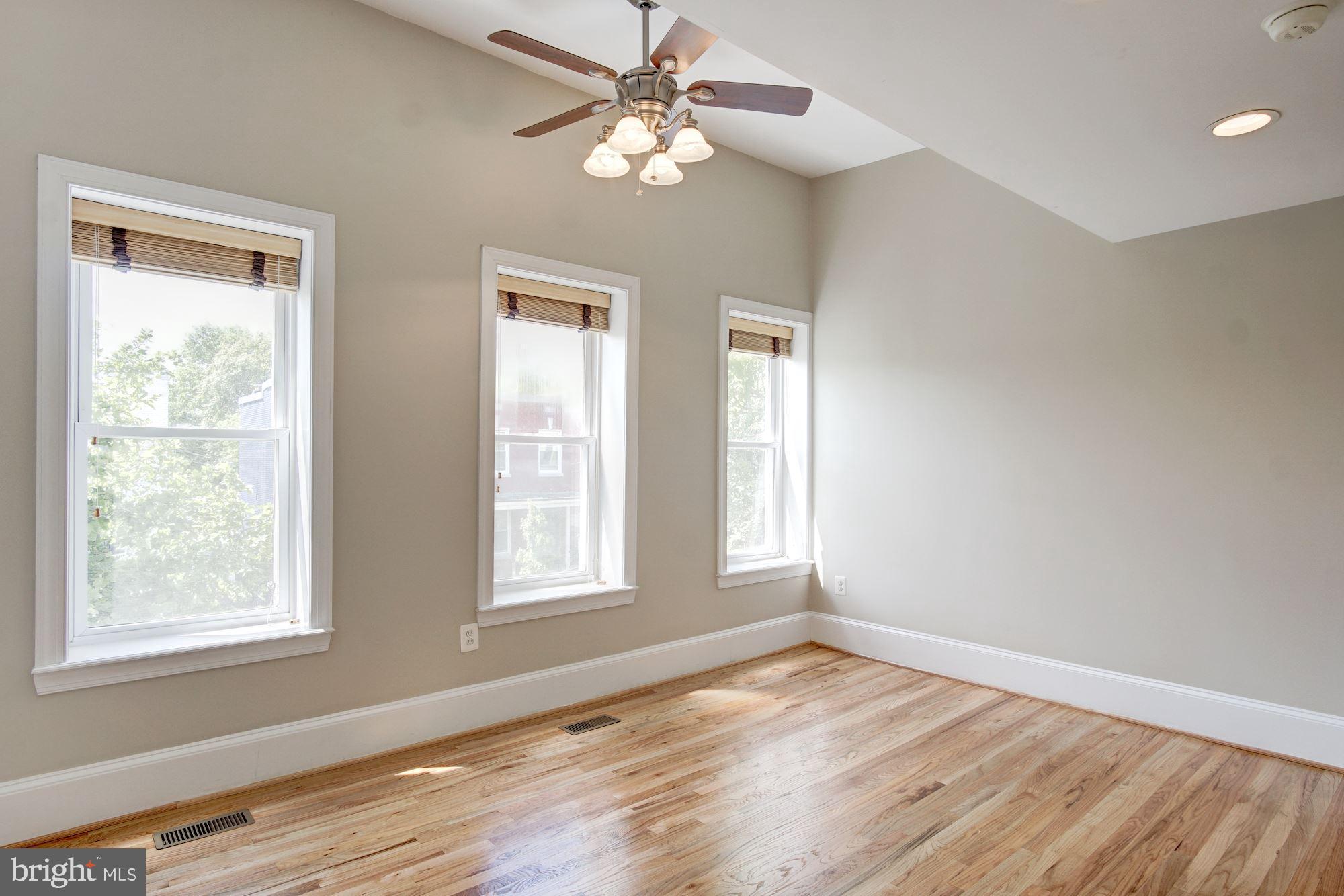 1414 D Street Northeast Washington, DC 20002 - Photo 13 of 25 a view of an empty room with wooden floor and a window