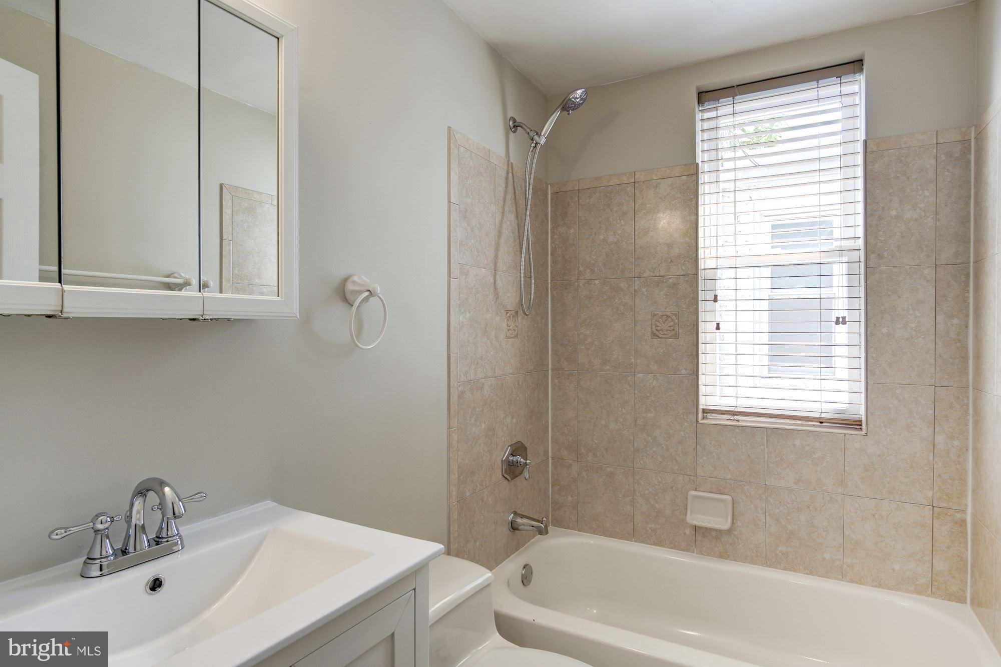1414 D Street Northeast Washington, DC 20002 - Photo 15 of 25 a bathroom with a sink a toilet and shower
