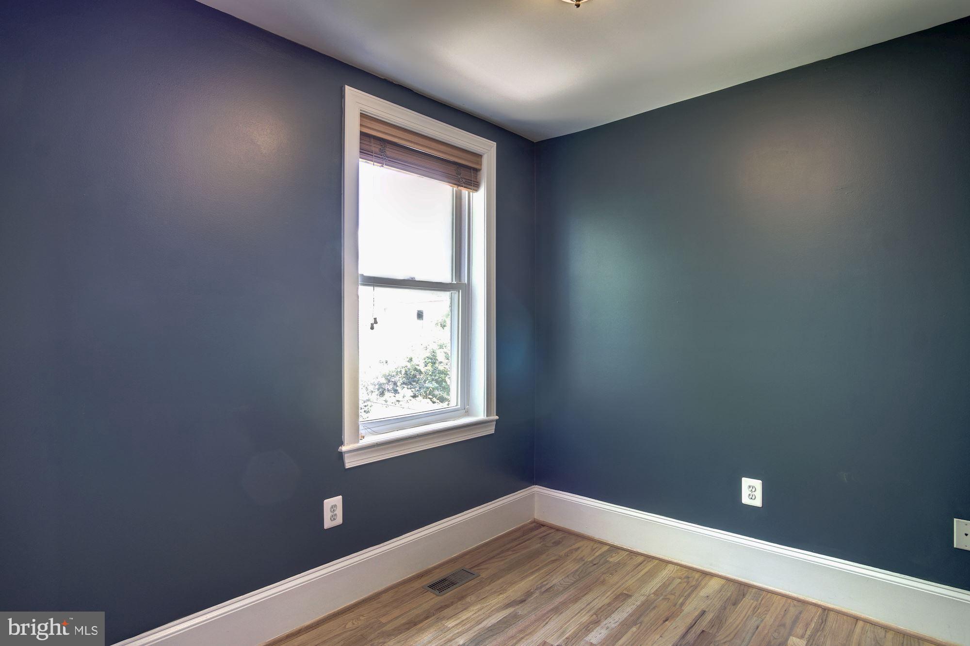 1414 D Street Northeast Washington, DC 20002 - Photo 16 of 25 an empty room with wooden floor and windows
