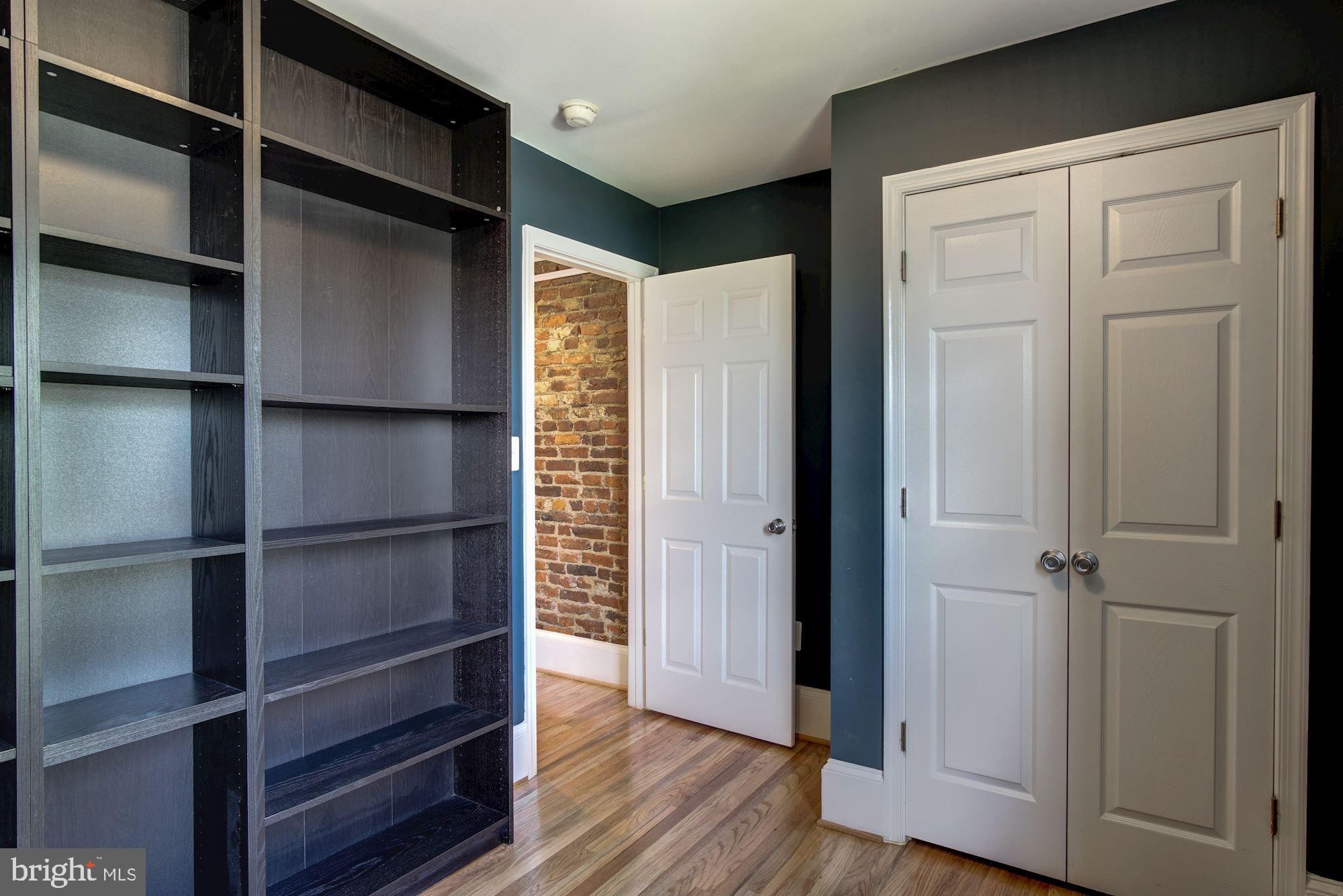 1414 D Street Northeast Washington, DC 20002 - Photo 17 of 25 a view of walk in closet with empty racks