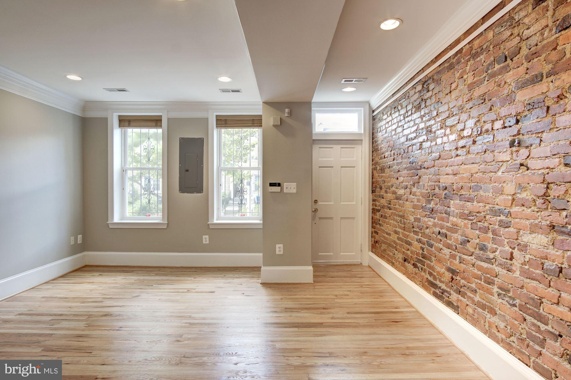 1414 D Street Northeast Washington, DC 20002 - Photo 3 of 25 a view of an empty room with wooden floor and a window