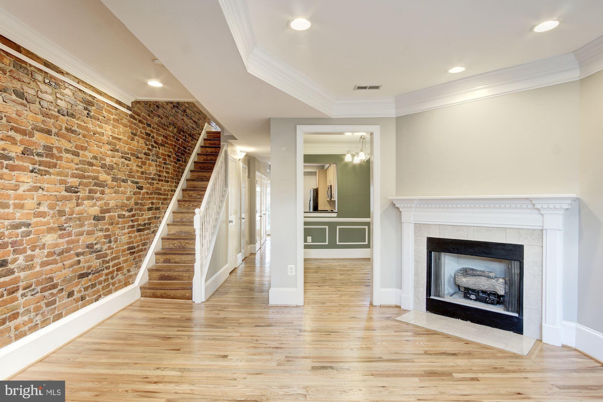 1414 D Street Northeast Washington, DC 20002 - Photo 4 of 25 a view of a livingroom with wooden floor and a fireplace
