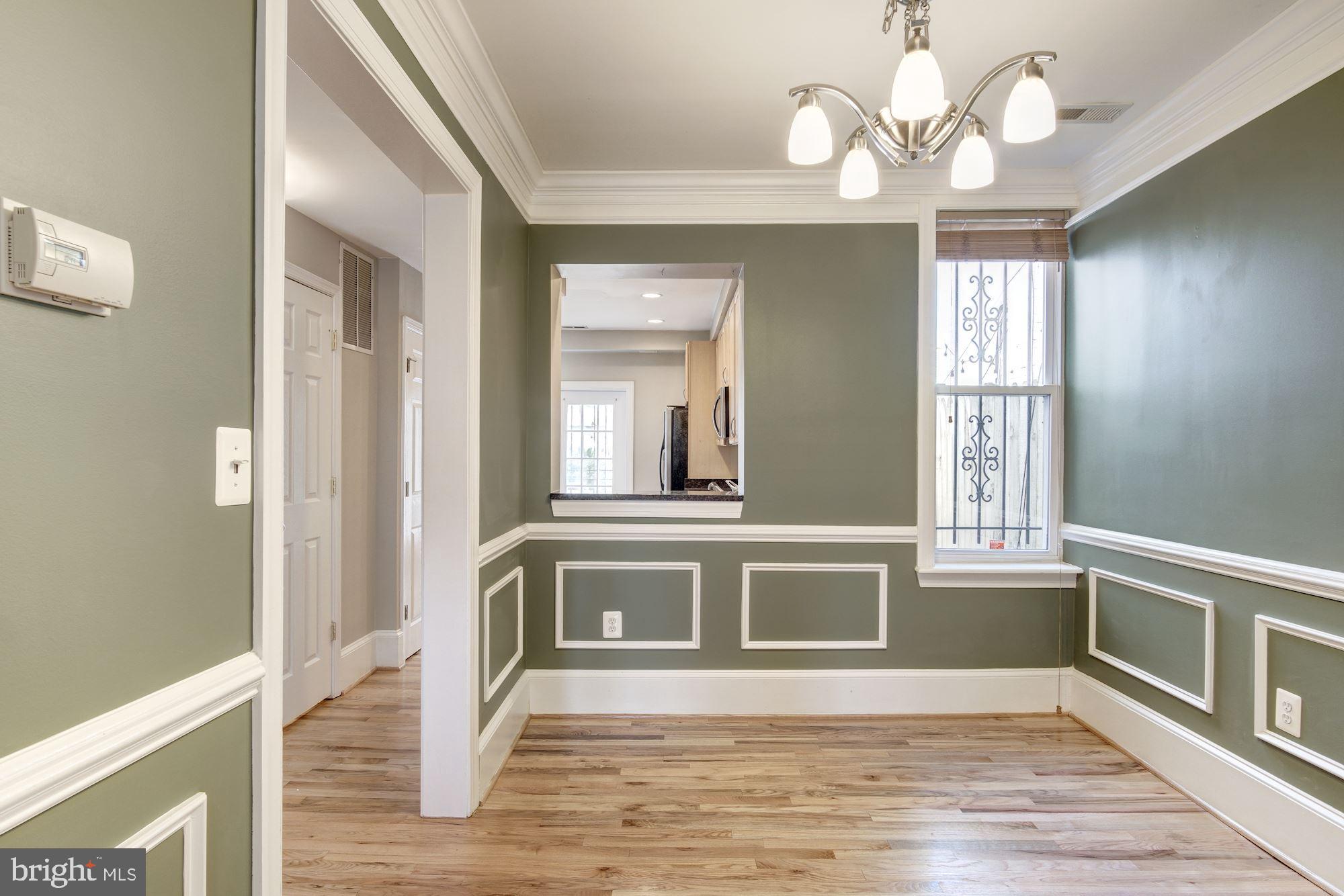 1414 D Street Northeast Washington, DC 20002 - Photo 5 of 25 a view of an empty room with wooden floor and a window