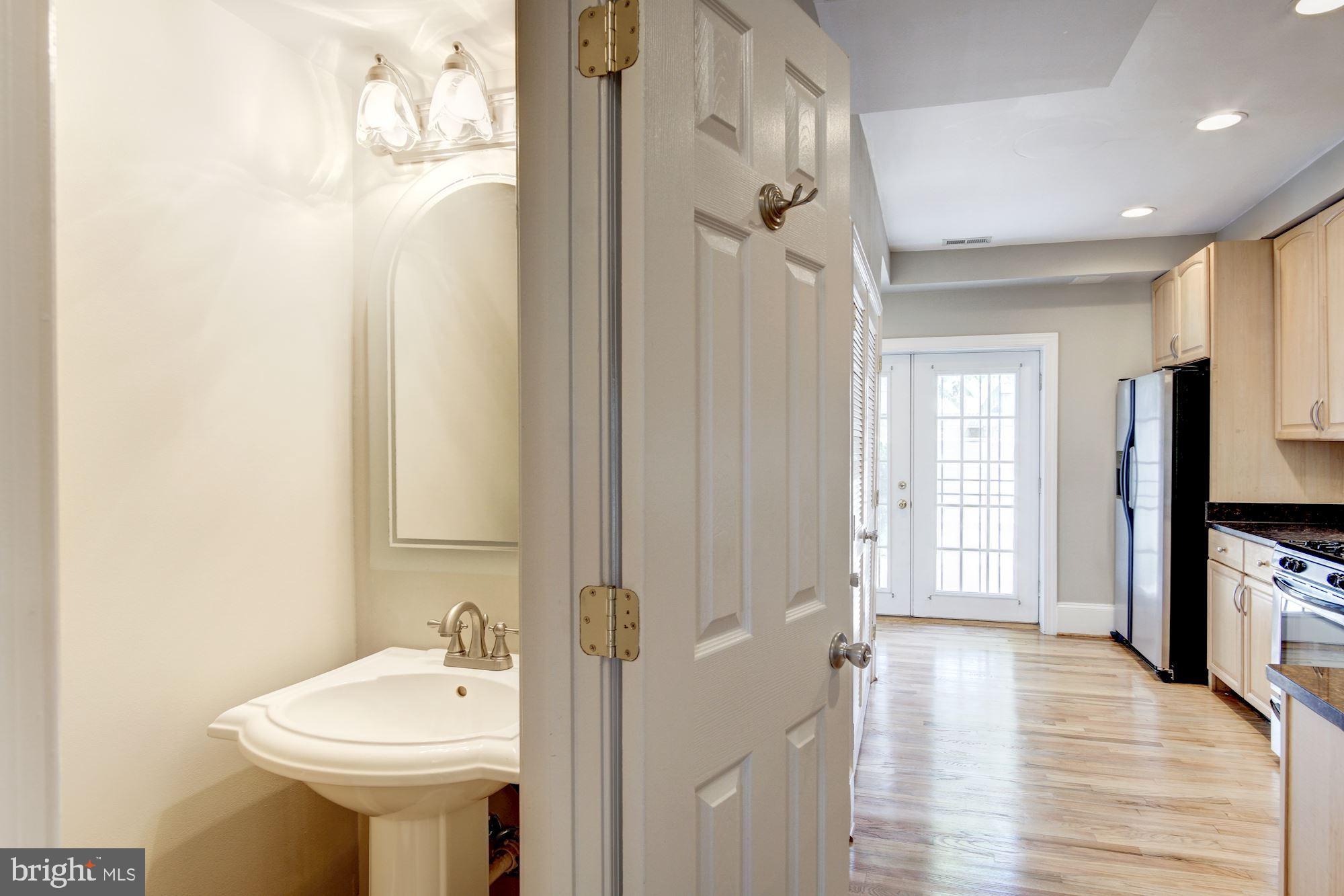 1414 D Street Northeast Washington, DC 20002 - Photo 9 of 25 a bathroom with a sink a mirror and a shower
