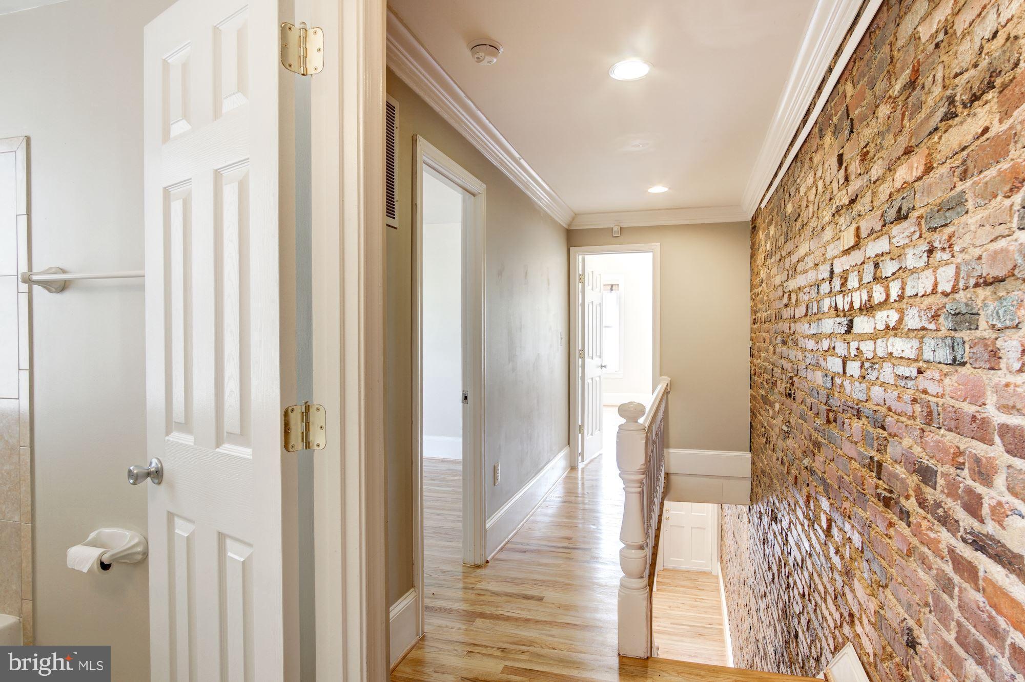 1414 D Street Northeast Washington, DC 20002 - Photo 10 of 25 a view of a hallway with wooden floor and staircase