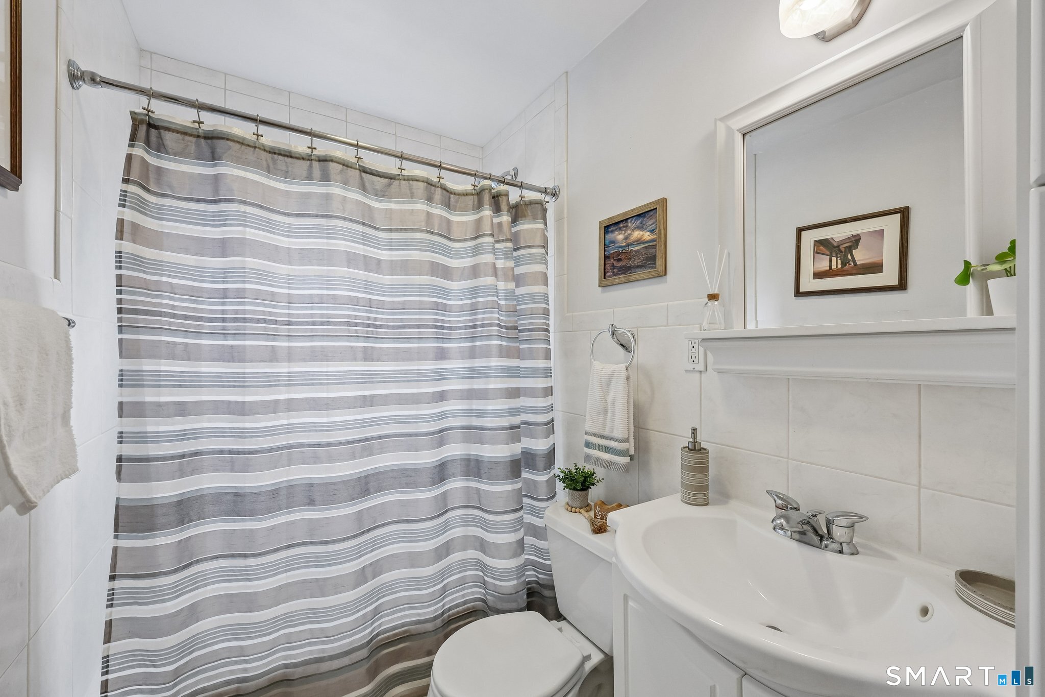 21 Friendly Road Norwalk, CT 06851 - Photo 8 of 28 Updated full bathroom on main level with a tub/shower combination, tile floors, new vanity. The all white background gives you a blank canvas to decorate!