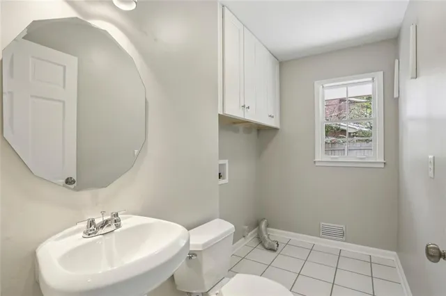 a bathroom with a sink mirror and toilet