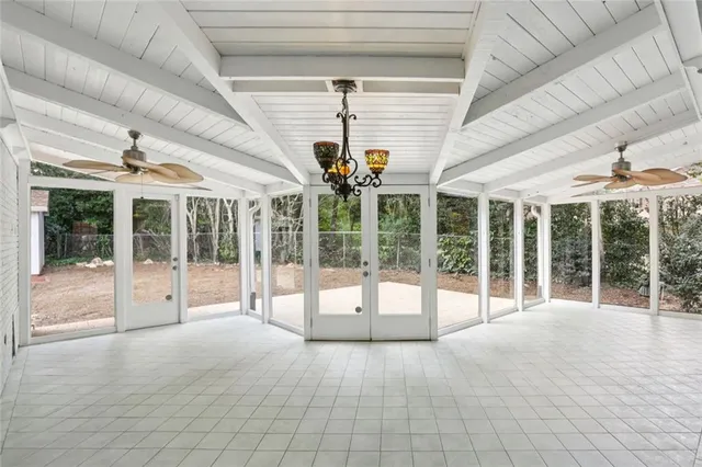 a view of a hall with floor to ceiling windows and an entrance