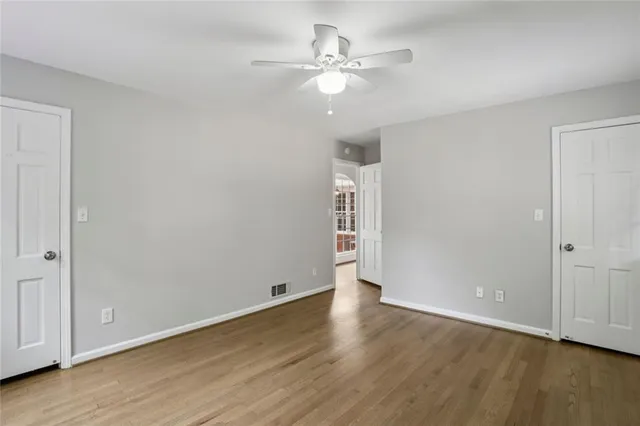 a view of an empty room with wooden floor