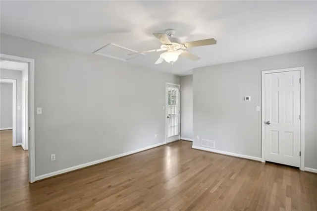 a view of an empty room with wooden floor