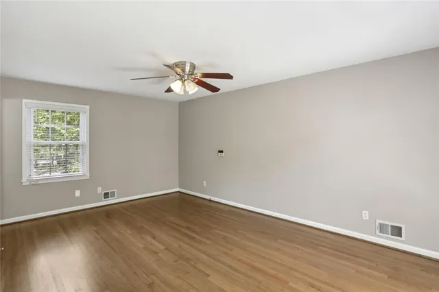 wooden floor in an empty room with a window