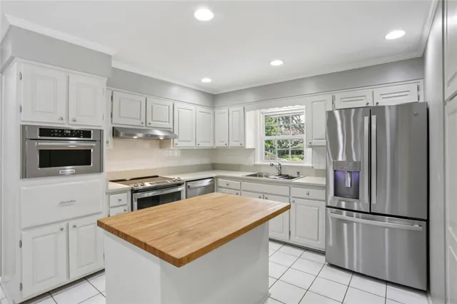 a kitchen with a stove a sink and a refrigerator