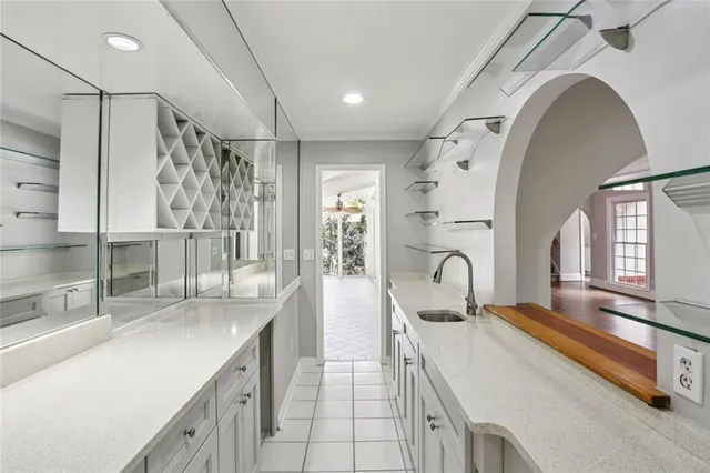 a kitchen with stainless steel appliances granite countertop a sink and a refrigerator