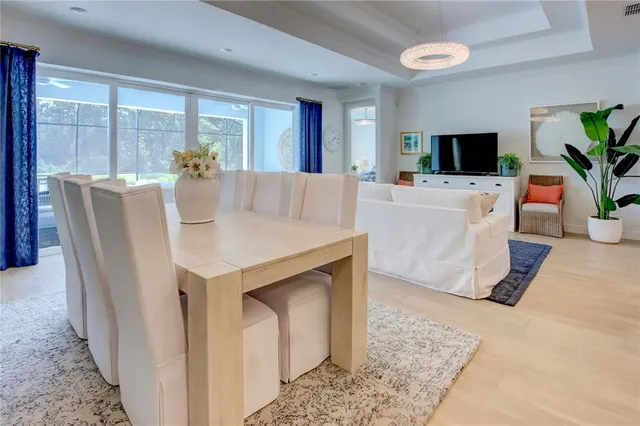 a living room with furniture a wooden floor and next to a window