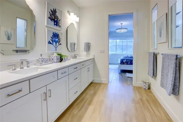 a bathroom with double vanity sink and a mirror
