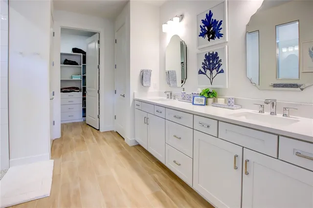 a spacious bathroom with a sink and a mirror