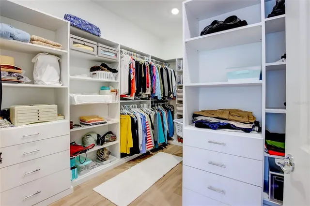 a room with painting on the wall and a wooden floor