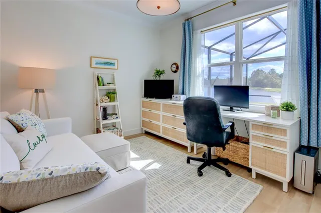 a view of an empty room with wooden floor and cabinet