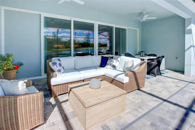 a living room with furniture a table and a large window