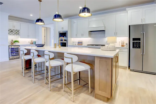 a kitchen with kitchen island granite countertop a counter space dining table and stainless steel appliances