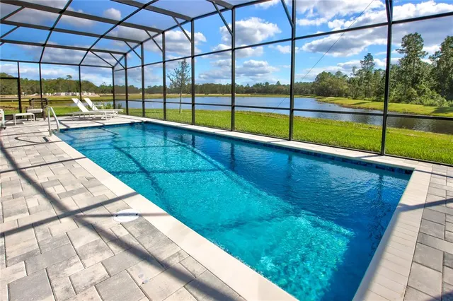 a view of a swimming pool with a yard