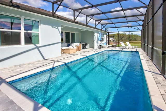a view of swimming pool with a patio