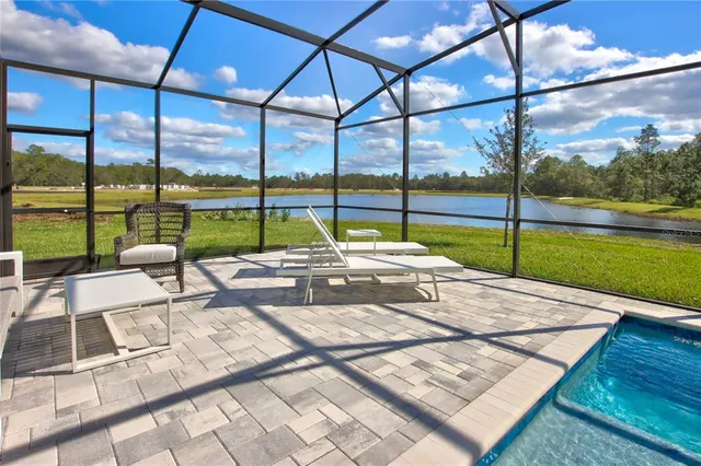 a view of a backyard with a garden and lake